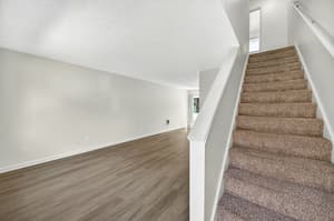 Spacious living room with wood floors and neutral walls at Lincoln Court in Fairview, Oregon