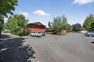Exterior with parking lot, red buildings at Lincoln Court Townhomes, 230 Lincoln Street, Fairview, Oregon 97024
