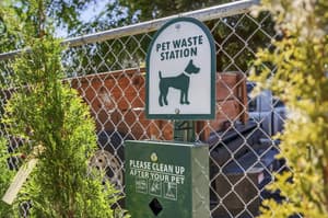 Exterior with pet waste station, chain link fence at Lincoln Court Townhomes, 230 Lincoln Street, Fairview, Oregon 97024
